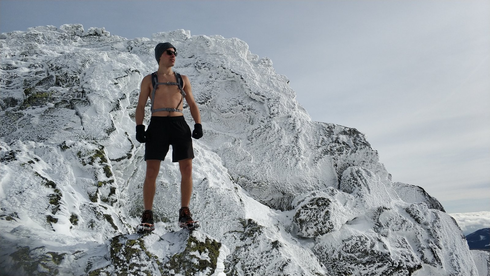 Filip on Mount Sniezka in winter wearing shorts