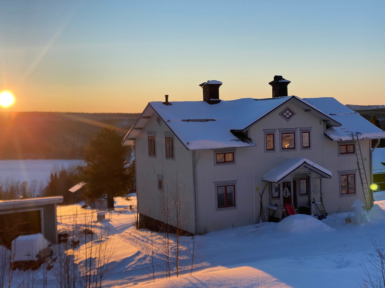 The be.human.natural retreat house in the snowy Swedish landscape at sunset